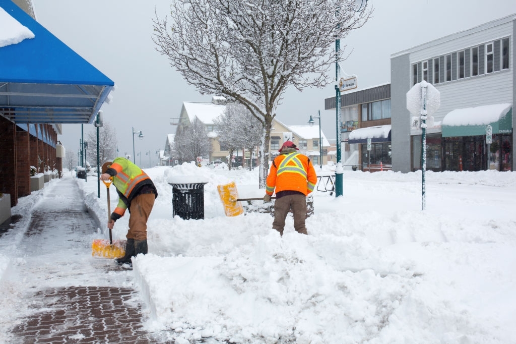 people-manually-clearing-snows