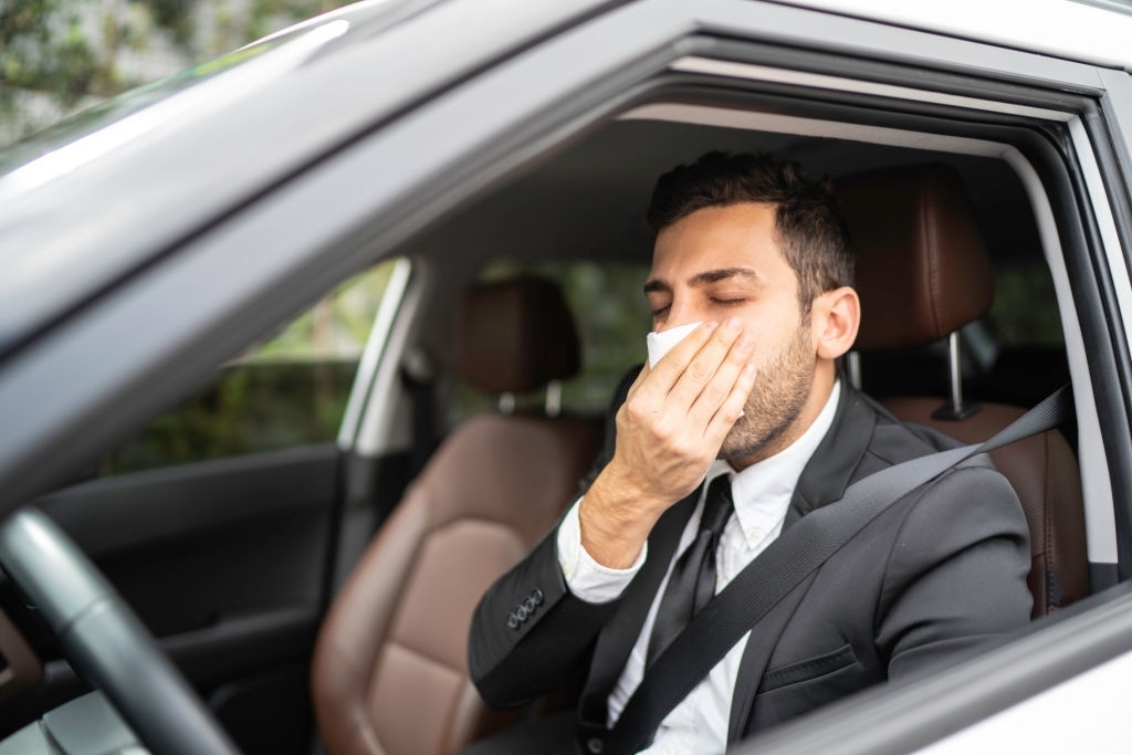 man-having-allergies-inside-the-car